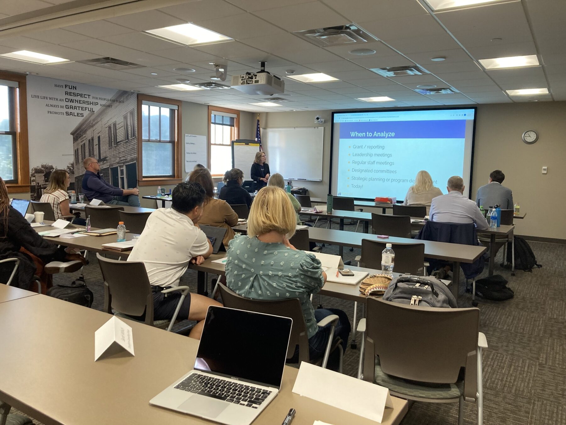 Data Informed Organization Grow Training. Image of group of people in classroom looking at projector